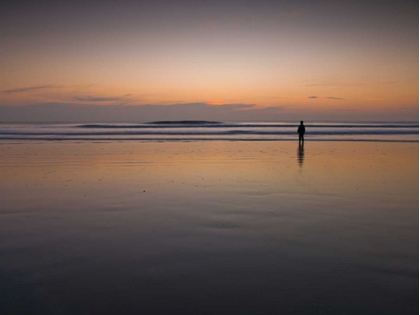 Picture of LITTLE BOY STANDING ON THE BEACH AT DUSK