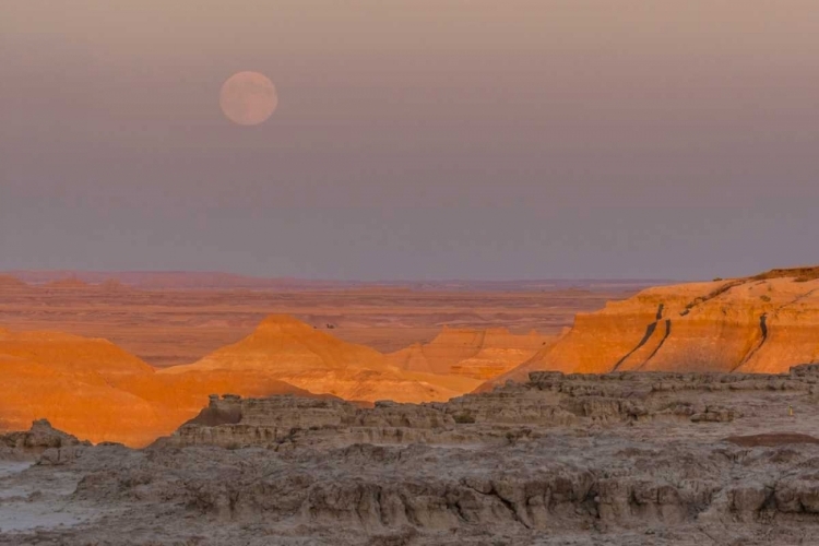 Picture of SD, BADLANDS NP MOONRISE OVER RUGGED LANDSCAPE