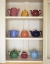 Picture of ANTIQUE CERAMIC TEAPOTS AND SUGAR BOWLS IN CUPBOARD