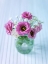 Picture of COLORFUL LISIANTHUS FLOWERS IN GLASS BOTTLE