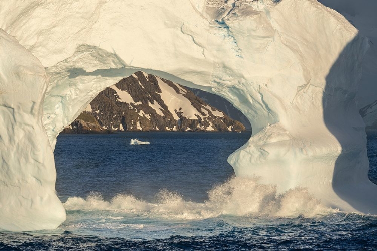 Picture of ANTARCTICA-SOUTH GEORGIA ISLAND-COOPERS BAY ICEBERG ARCH AND MOUNTAINS AT SUNRISE 