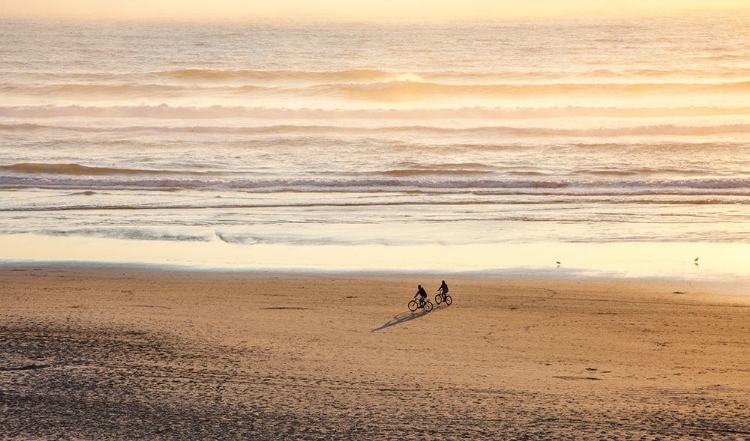 Picture of OREGON-CAPE ARCH WITH TWO RIDING BIKES ON THE BEACH IN THE EVENING LIGHT