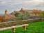 Picture of ITALY-TUSCANY-PROVINCE OF SIENA-MONTALCINO STONE BENCH OVERLOOKING THE TOWN OF MONTALCINO