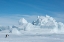 Picture of ANTARCTICA-WEDDELL SEA-SNOW HILL. EMPEROR PENGUIN WITH ICEBERG IN THE DISTANCE.