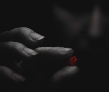 Picture of BROKEN RED HEART IN THE MOODY GIRLS HANDS.