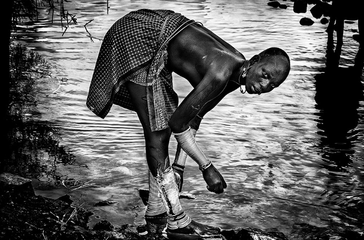 Picture of SURMA TRIBE WOMAN WASHING UP HER JEWELRY - ETHIOPIA