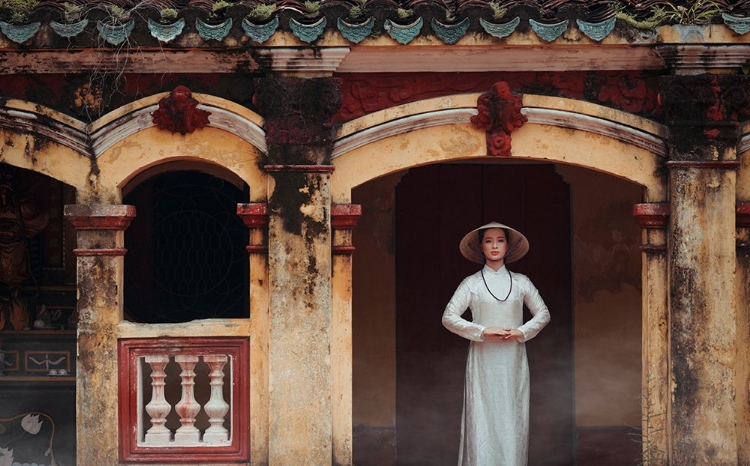 Picture of A VIETNAMESE GIRL IN A TRADITIONAL AO DAI DRESS IS PRAYING FOR HAPPINESS